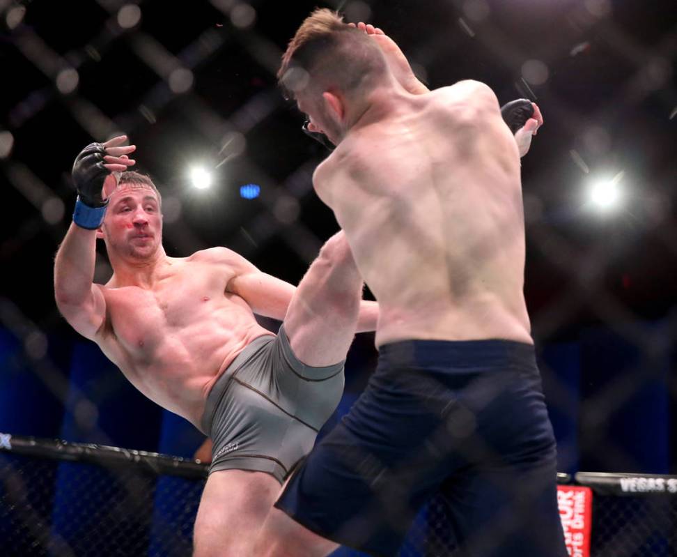 Brendan Loughnane lands a kick to Bill Algeoin the second round of their featherweight bout on ...