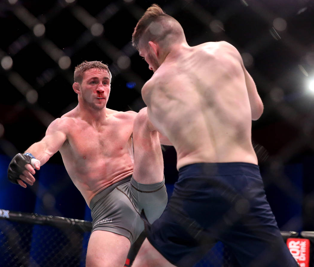 Brendan Loughnane lands a kick to Bill Algeoin the second round of their featherweight bout on ...
