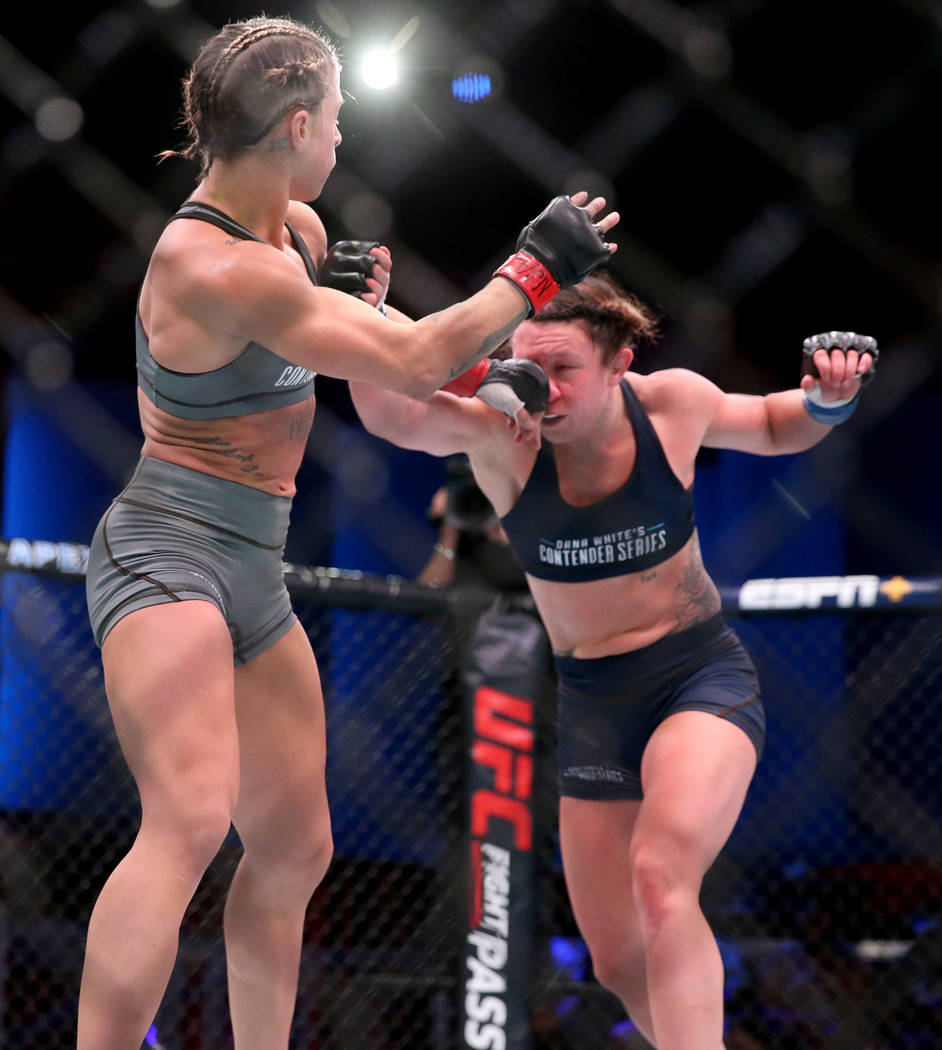 Hannah Goldy lands a punch to Kali Robbins in the third round of their strawweight bout on the ...