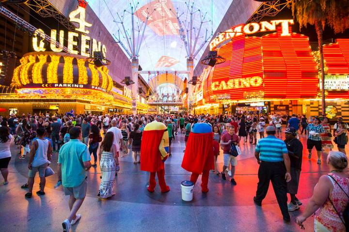 Buskers wait to pose with tourists for tips along the Fremont Street Experience in downtown Las ...