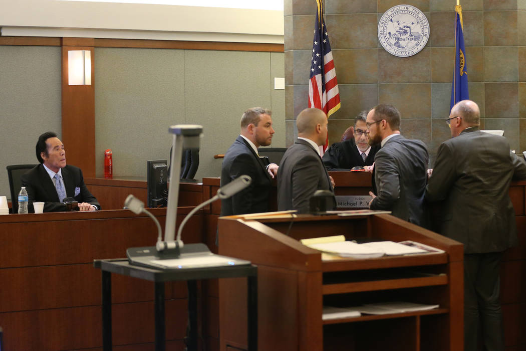 Wayne Newton, left, takes the witness stand in the State of Nevada case against Weslie Martin, ...