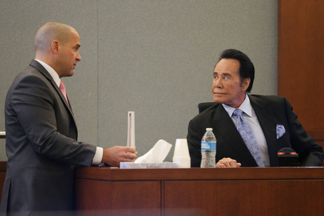 District Attorney John Giordani, left, speaks to Wayne Newton sitting in the witness stand, in ...