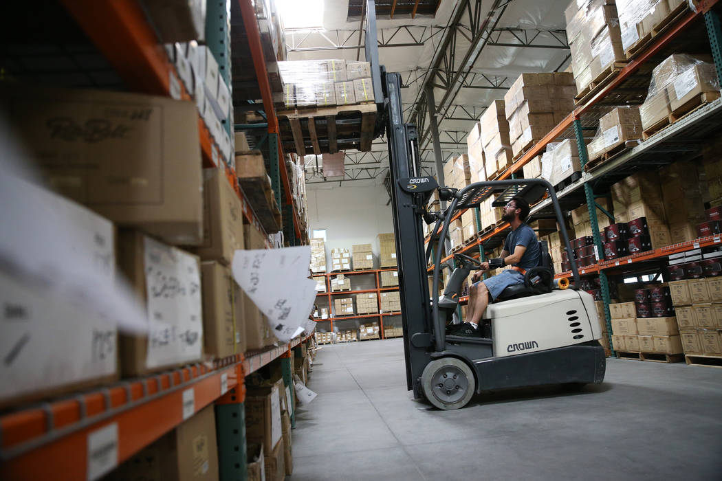 Warehouse associate Thomas Shirley works a fork lift at the Retro Manufacturing headquarters in ...