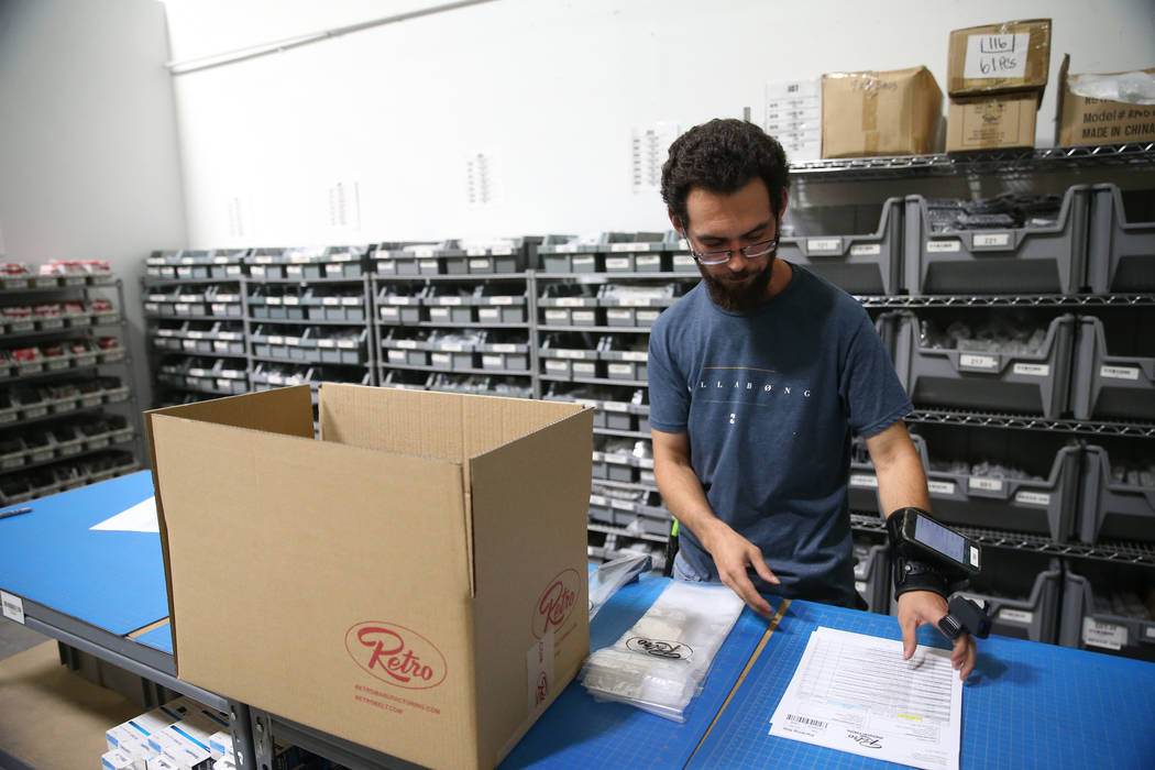 Warehouse associate Thomas Shirley fills an order at Retro Manufacturing headquarters in Hender ...