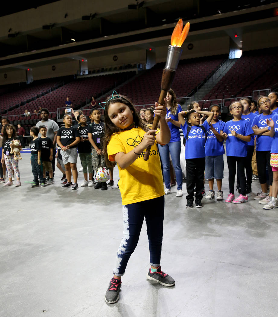 Arian Diaz Medina, 8, carries the torch on Olympic Day at The Orleans in Las Vegas Tuesday, Jun ...