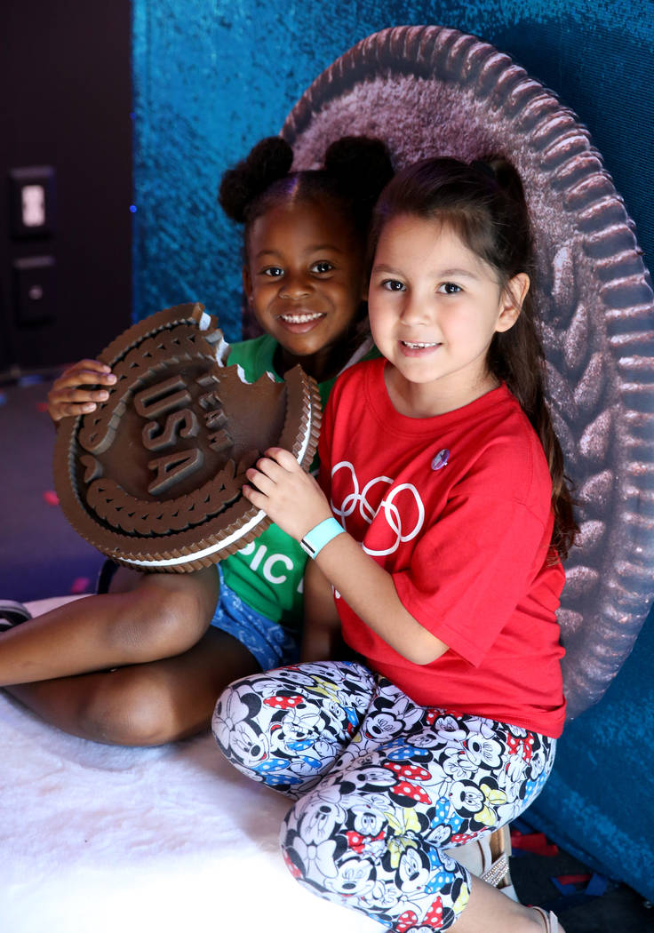 Khilyne Vergo, 6, and Arianny Martinez, 5, pose in the Team USA Social Experience Truck on Olym ...