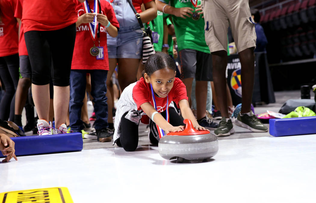 Harena Tewelde, 12, of Lied Boys & Girls Club tries curling on Olympic Day at the Orleans A ...