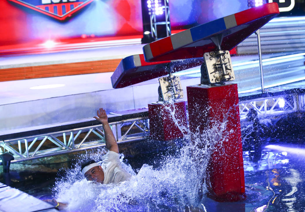 Adrian Hernandez of Hot 97.5 falls to the water while attempting the first obstacle from stage ...