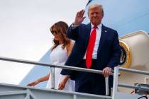 President Donald Trump and first lady Melania Trump arrive at Orlando International Airport for ...