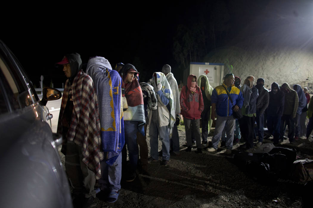 In an Aug. 31, 2018, file photo, Venezuelan migrants line up for free bread and coffee, donated ...