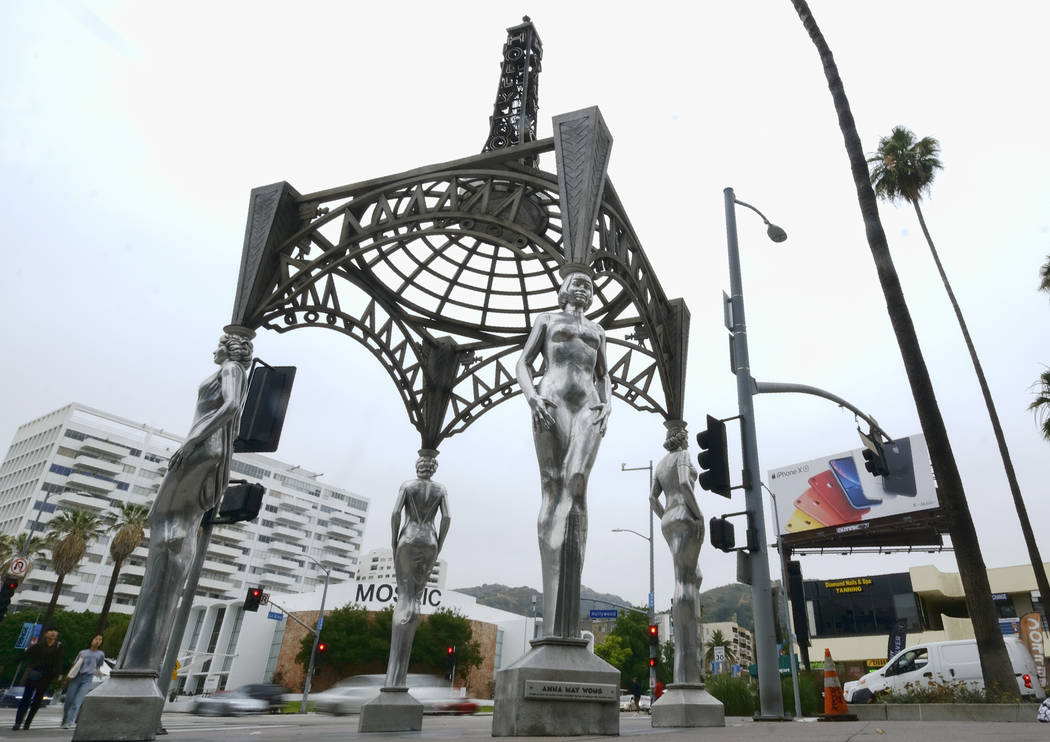 Pedestrians walk past the "Four Ladies of Hollywood" gazebo on Hollywood Boulevard in ...