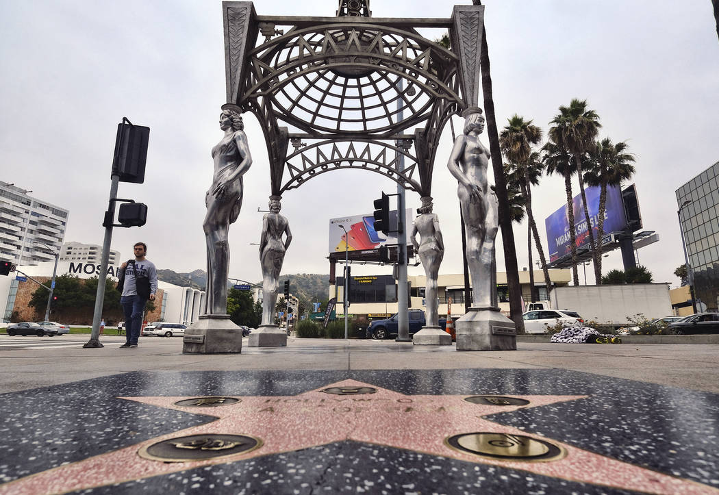 A pedestrian walks past the "Four Ladies of Hollywood" gazebo on Hollywood Boulevard ...