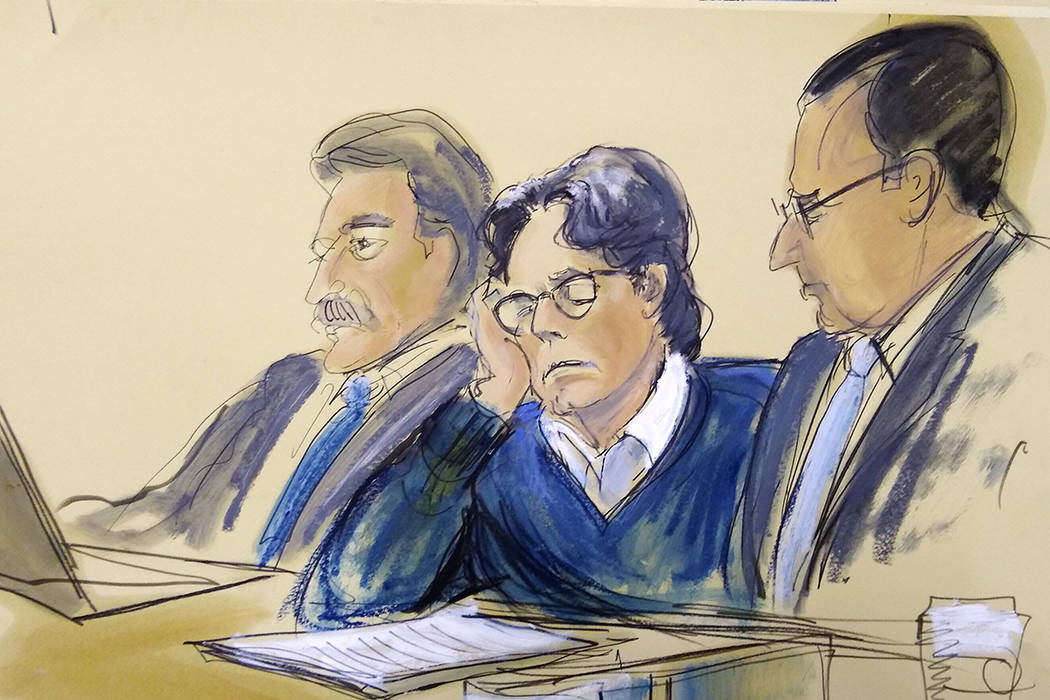 In this courtroom artist's sketch, defendant Keith Raniere, center, sits with attorneys Paul De ...
