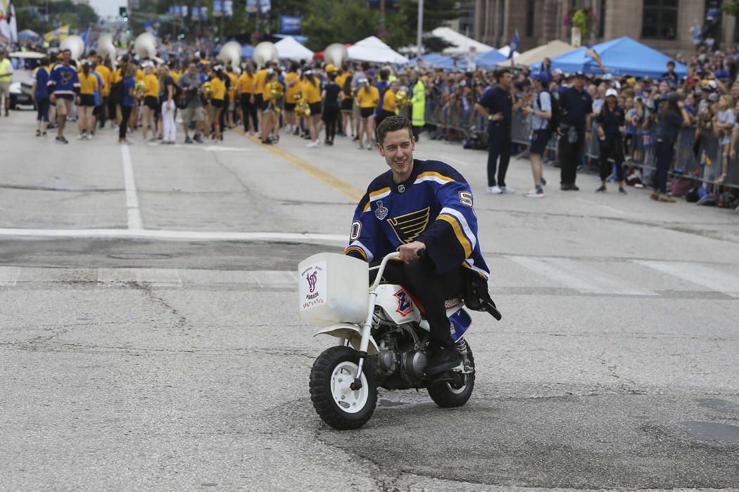 St. Louis Blues goaltender Jordan Binnington rides a bike during the NHL hockey Stanley Cup vic ...