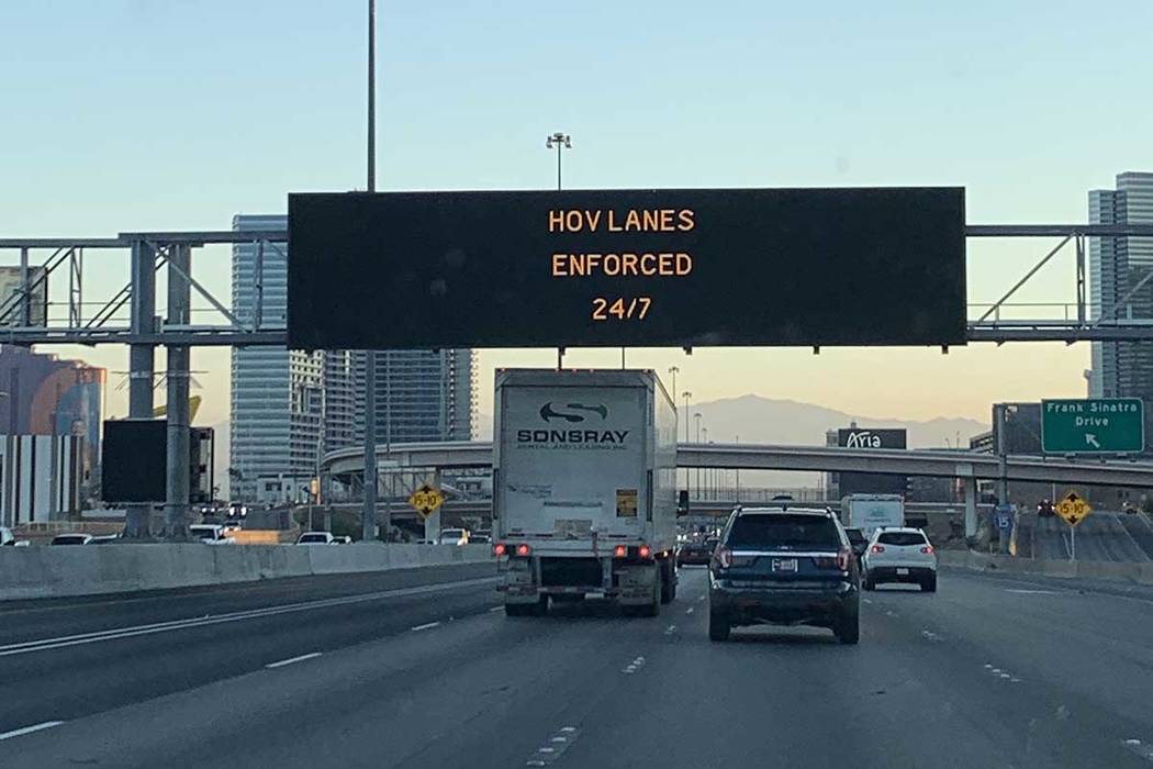 An electronic sign on Interstate 15 advises drivers of HOV enforcement, Thursday, June 20, 2019 ...