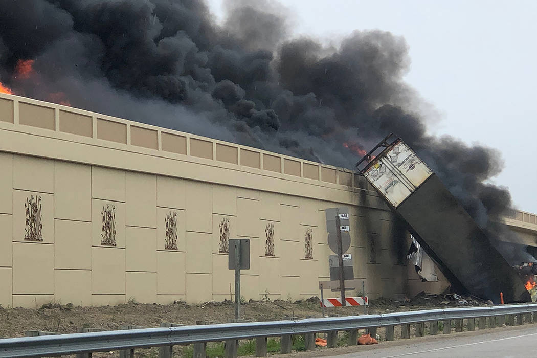 Smoke billows from a semi after a deadly crash on Interstate 94 in Caledonia, Wis., Wednesday, ...