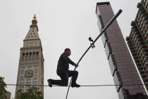 High-Wire Artist Nik Wallenda is famed by the Met Life building as he walks a tight rope, in ho ...