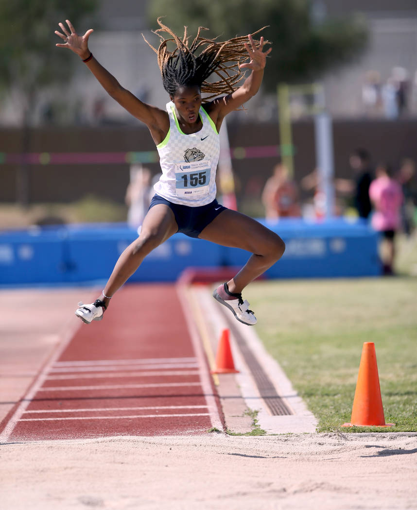 Ashley Moore of Centennial competes in the triple jump during the Class 4A state track meet at ...