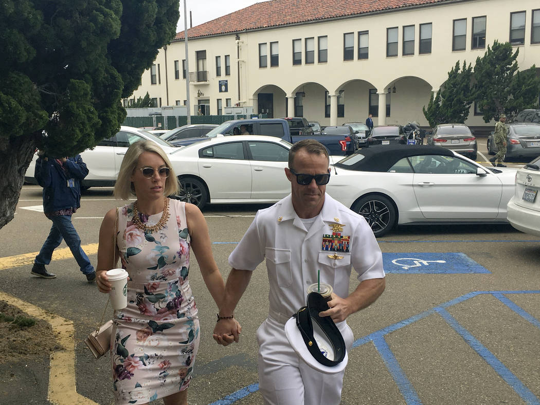 Navy Special Operations Chief Edward Gallagher, right, walks with his wife, Andrea Gallagher, a ...