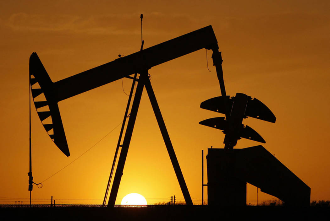 A pumpjack is silhouetted against the setting sun in Oklahoma City in 2012. (AP Photo/Sue Ogro ...