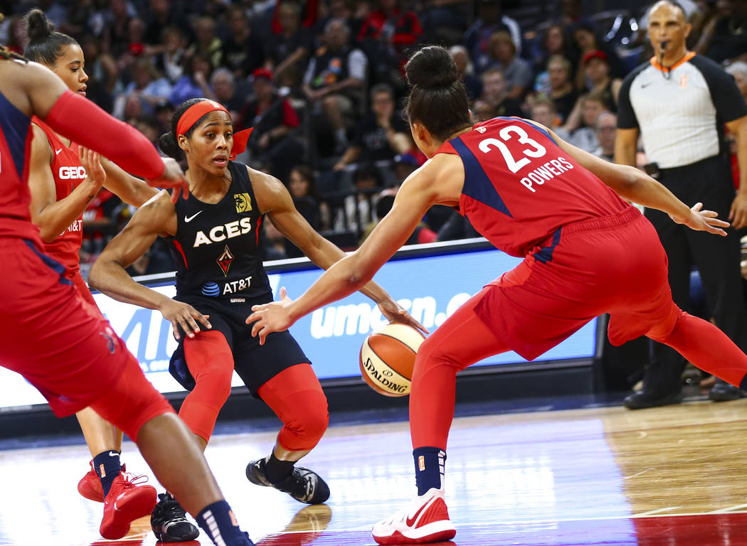 Las Vegas Aces guard Sydney Colson (51) moves the ball around Washington Mystics forward Aerial ...