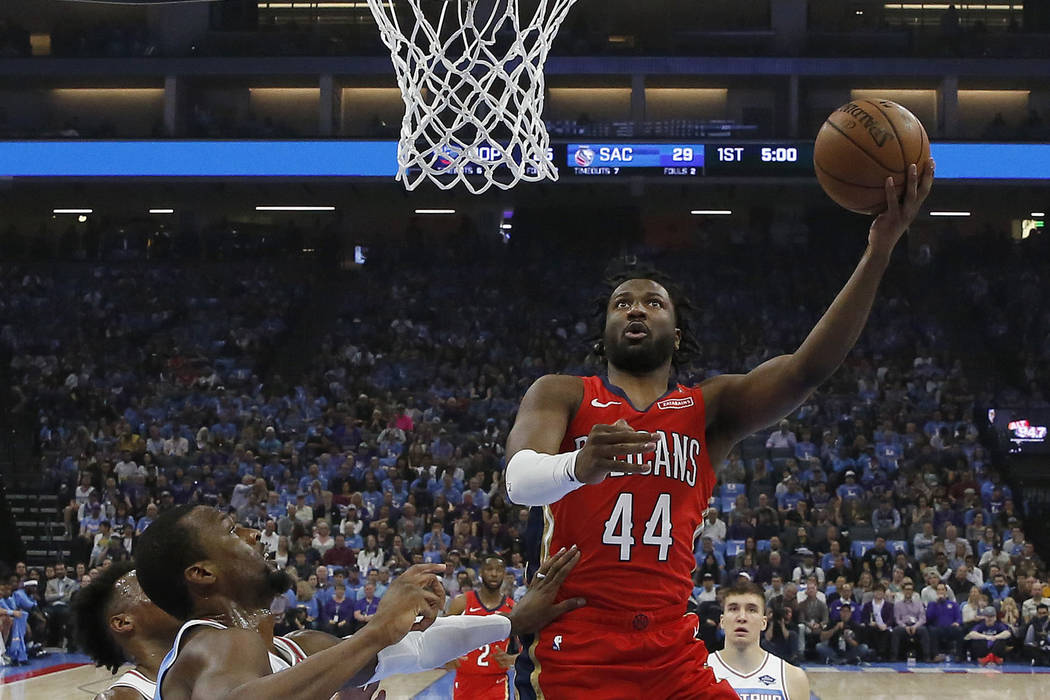 In this April 7, 2019 photo, New Orleans Pelicans forward Solomon Hill, right, goes to the bask ...