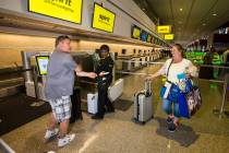Brian Kile, left, and Amy Conn-Kile, right, both of Chicago, walk up to the Spirit Airlines aut ...