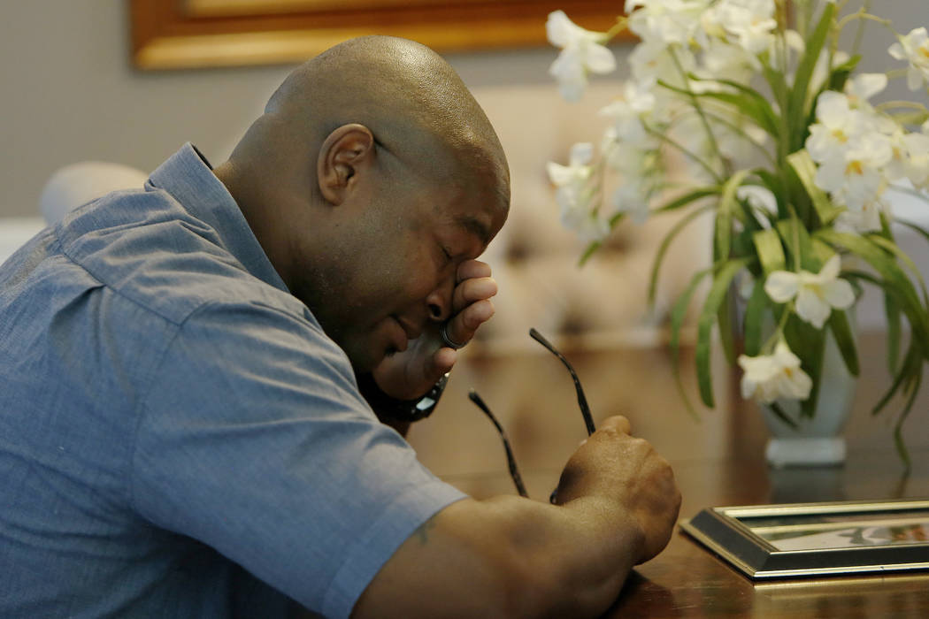 In this Friday, June 14, 2019 photo, Chris Parks wipes away a tear while talking about the murd ...