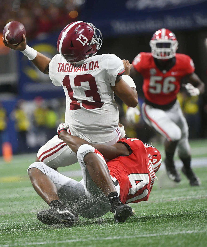 Georgia linebacker Channing Tindall (41) hits Alabama quarterback Tua Tagovailoa (13) during th ...