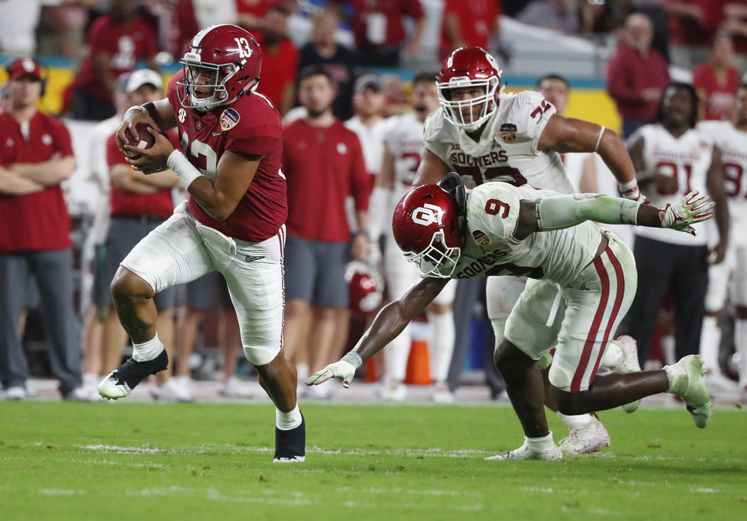 Alabama quarterback Tua Tagovailoa (13) avoids a tackle by Oklahoma linebacker Kenneth Murray ( ...