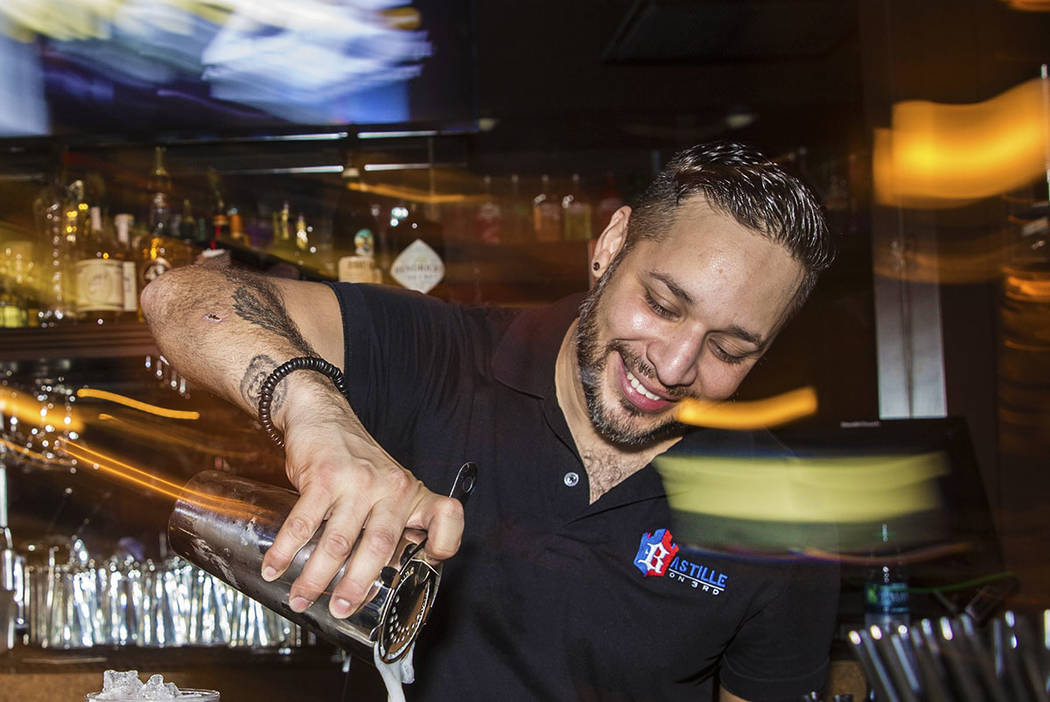 Bartender Eric Garcia makes drinks at Bastille on 3rd, the longest running LGBTQ bar in Las Veg ...