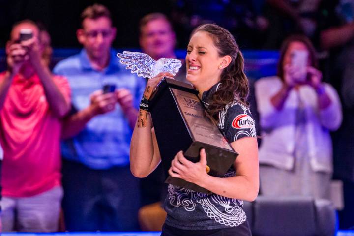 Danielle McEwan is overcome with emotion while holding the trophy after edging out Tanya Roumim ...