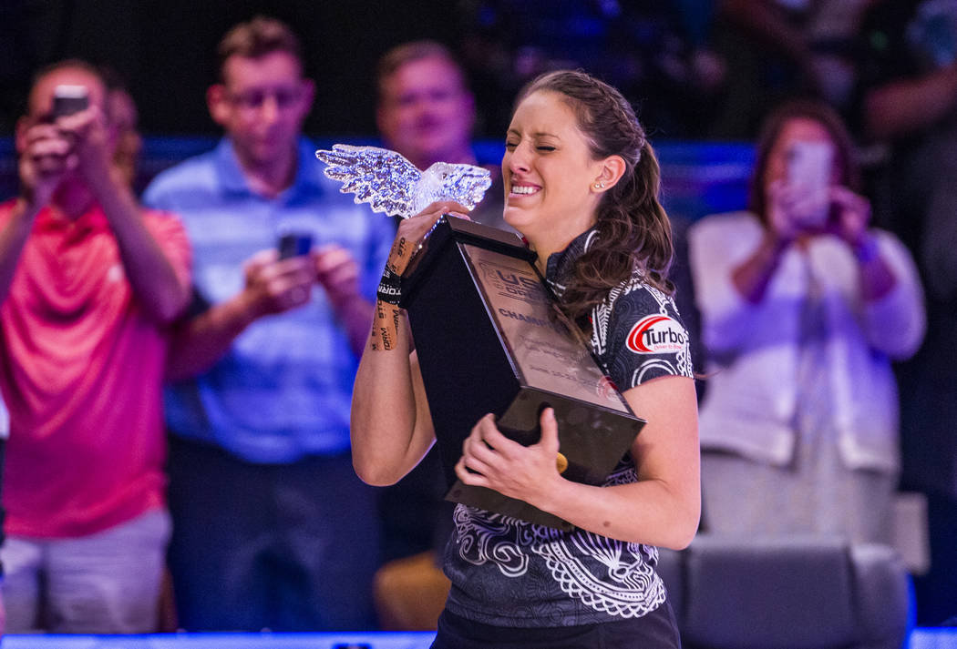 Danielle McEwan is overcome with emotion while holding the trophy after edging out Tanya Roumim ...