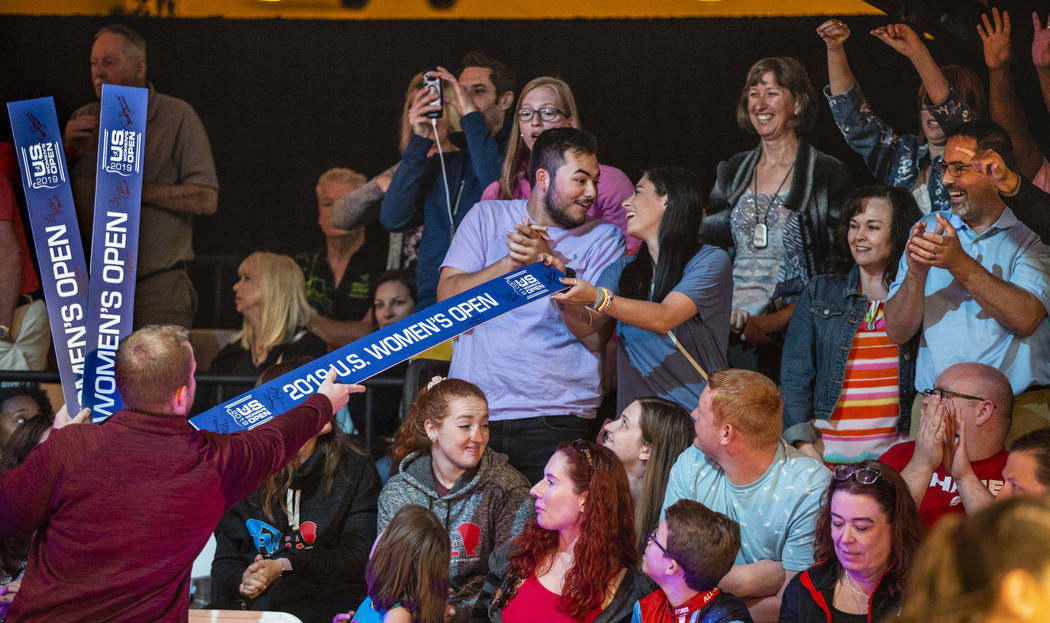 Brant Houghton with the USBC gives away tournament placards to the loudest fans during the U.S. ...