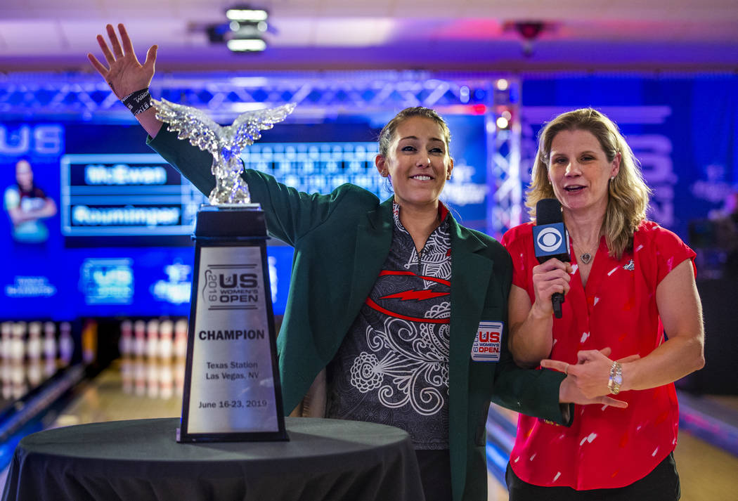 Danielle McEwan with announcer Kelly Kulick thanks her fans while wearing the signature winners ...