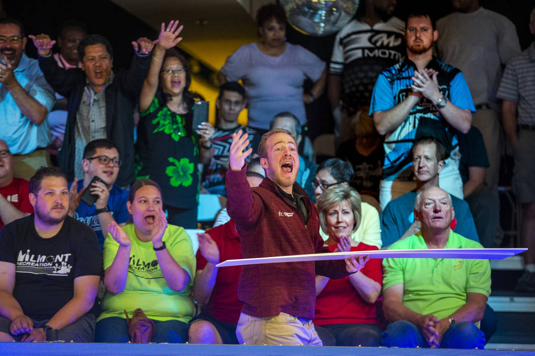 Brant Houghton with the USBC gives away tournament placards to the loudest fans during the U.S. ...