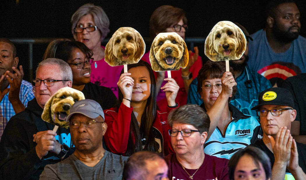 Fans hold up dog face placards when Shannon O'Keefe bowls a great frame in her semifinals match ...