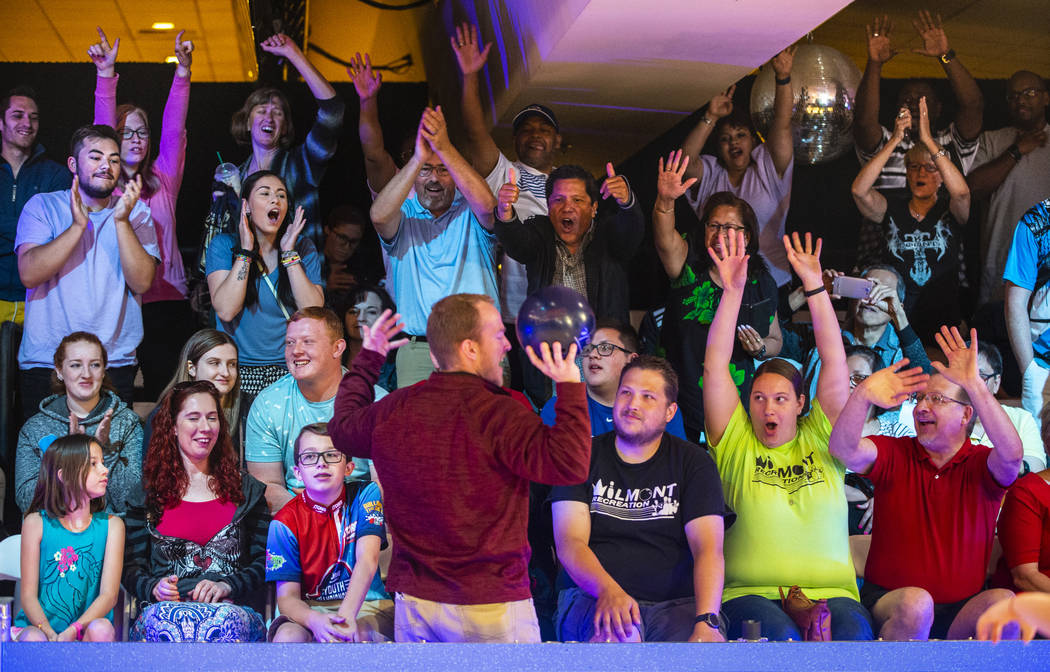 Brant Houghton with the USBC gives away player's bowling balls to the loudest fans during the U ...