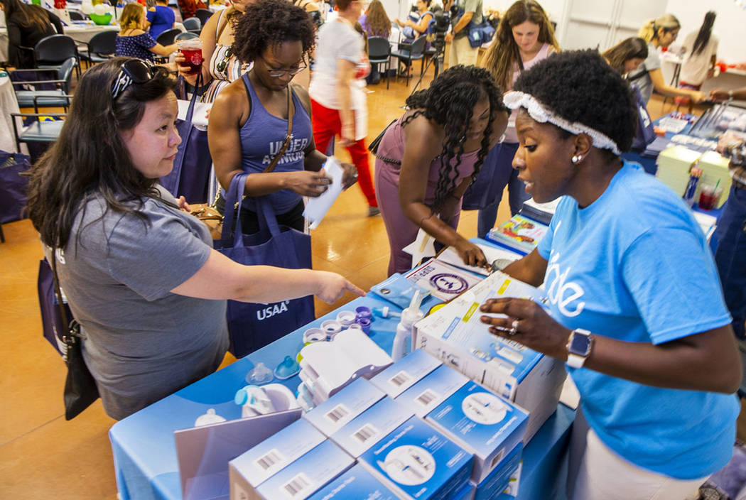 Kathy Mead-Torres (left) learns about the Kiinde Breastfeeding Kit from Aisha Fanning (right) a ...