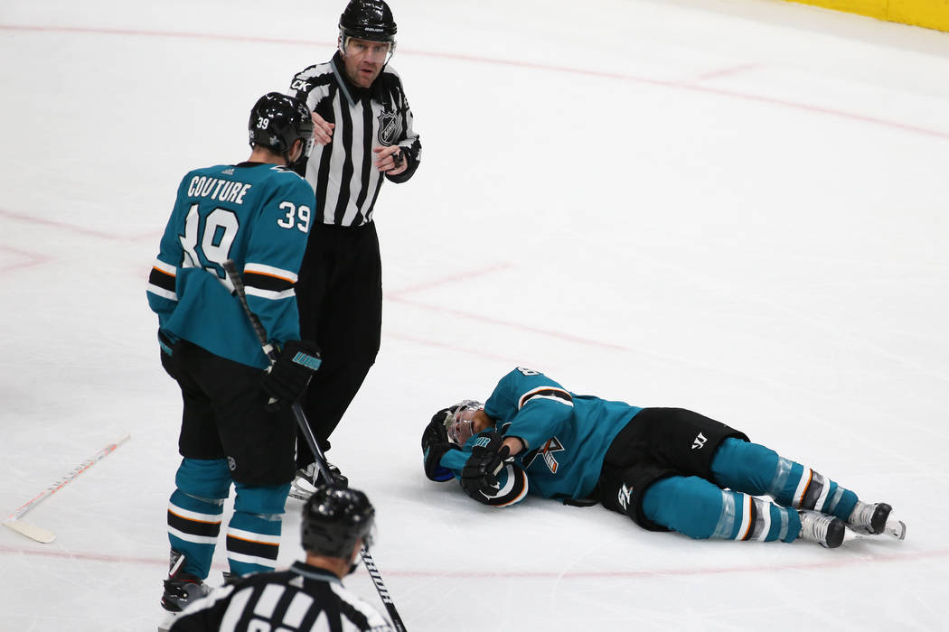 Sharks center Joe Pavelski (8) lays on the ice after getting hit by Knights center Cody Eakin ( ...