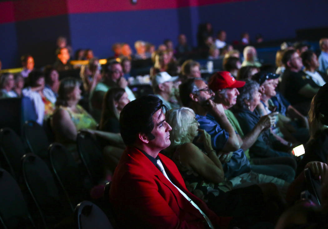Elvis tribute artist Rob Ely watches from the crowd after performing in the '50s era competitio ...