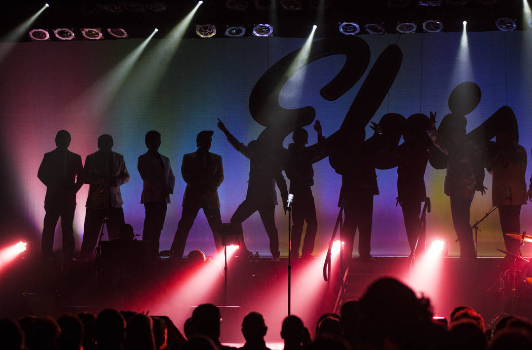 Elvis tribute artists are silhouetted on stage before the start of the '50s era competition dur ...