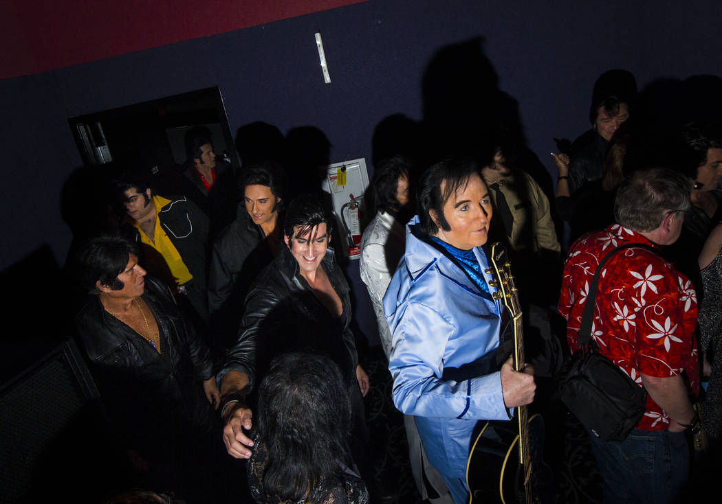 Elvis tribute artists, including Shane Paterson, of Henderson, in blue, make their way out of t ...