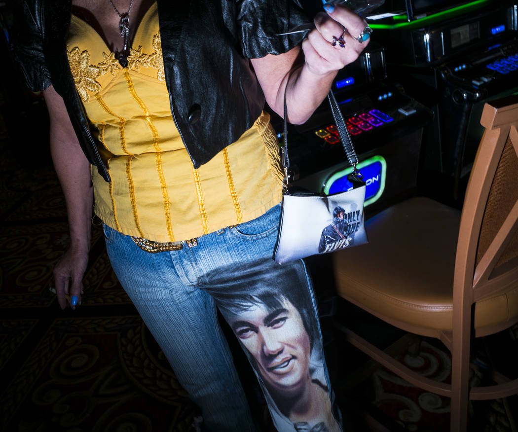 Elvis fan Jeanie Pusser shows off her custom denim and bag before attending the '70s era showca ...