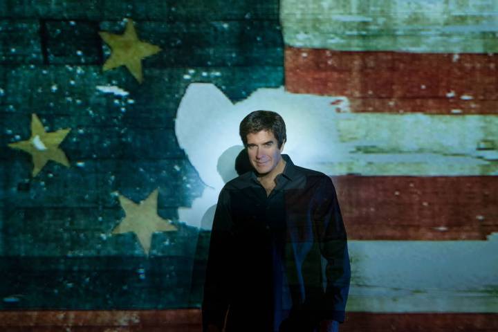 Magic legend David Copperfield is shown with an image of the original Star-Spangled Banner at t ...