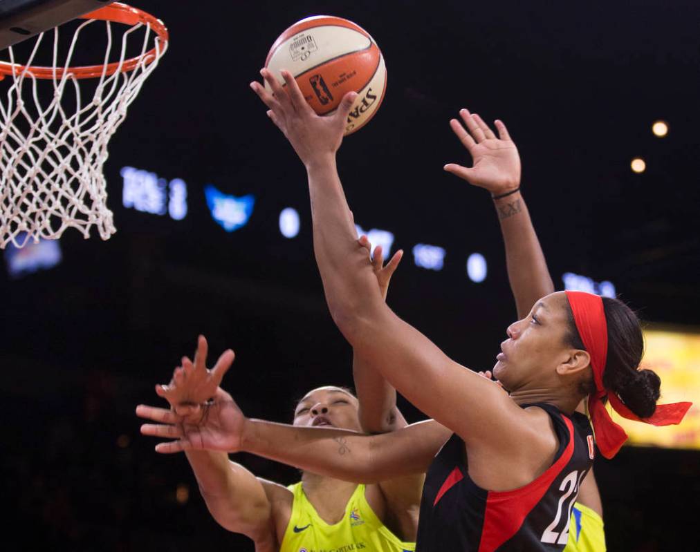 Las Vegas Aces center A'ja Wilson (22) slices to the rim past Dallas Wings center Imani McGee-S ...