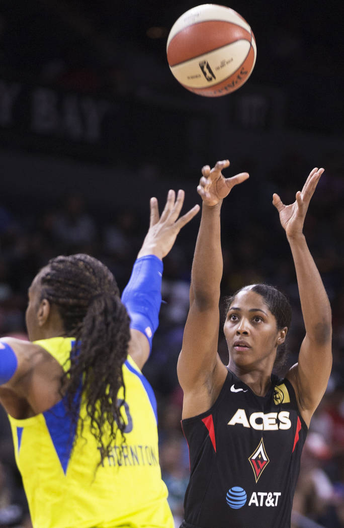 Las Vegas Aces guard Sydney Colson (51) shoots a jump shot over Dallas Wings forward Kayla Thor ...