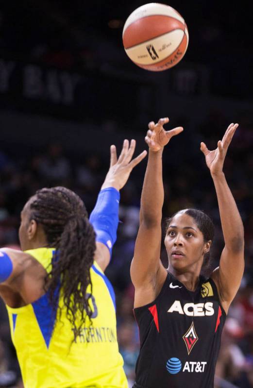 Las Vegas Aces guard Sydney Colson (51) shoots a jump shot over Dallas Wings forward Kayla Thor ...