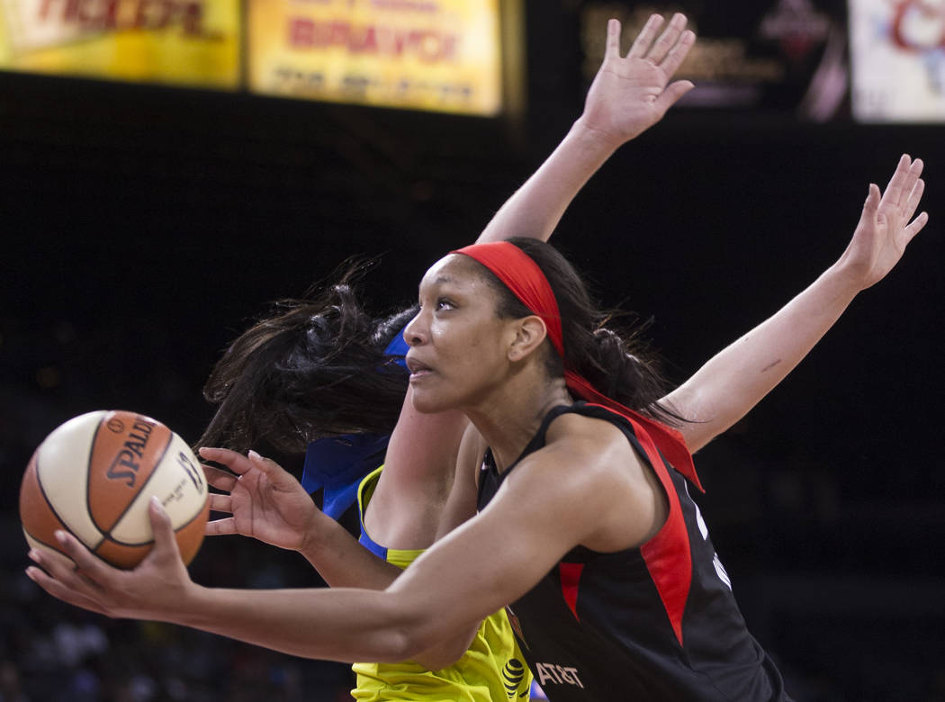 Las Vegas Aces center A'ja Wilson (22) slices to the rim past Dallas Wings forward Megan Gustaf ...