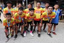 Members of the Wild Boars soccer team who were rescued from a flooded cave, pose for the media ...